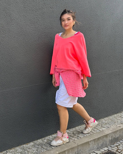 Sweater hand stitched in neon coral