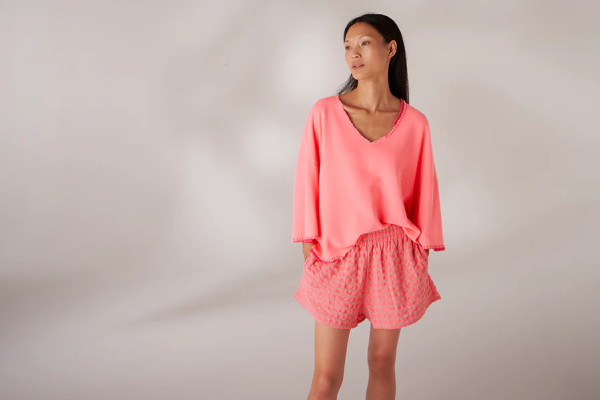 Sweater hand stitched in neon coral